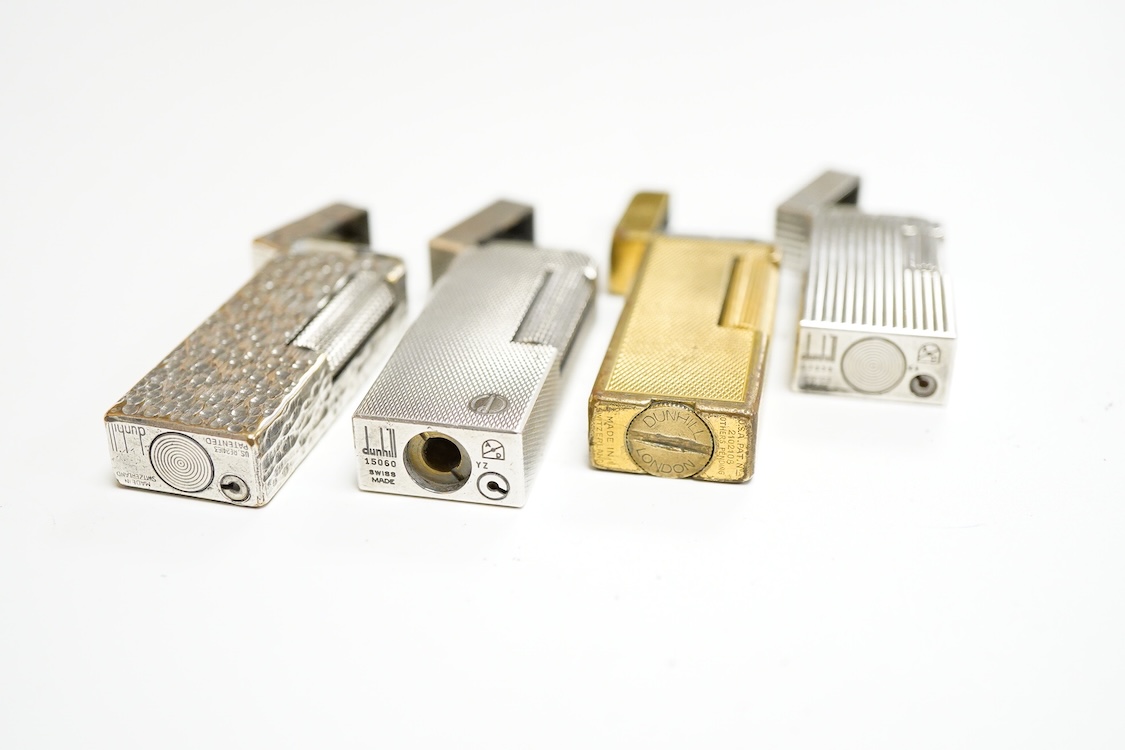 Three assorted plated Dunhill lighters and a gilt example, largest 6.5cm high